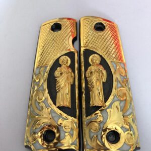 Gold plated govermment 1911 gun grips Mexican Narco style Cachas Golden San Judas Black Background