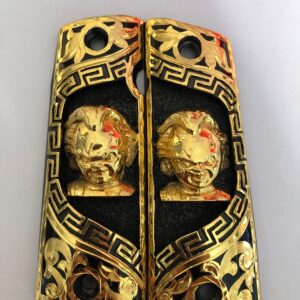 Gold plated govermment 1911 gun grips Mexican Narco style Cachas Golden Chucky Black Background